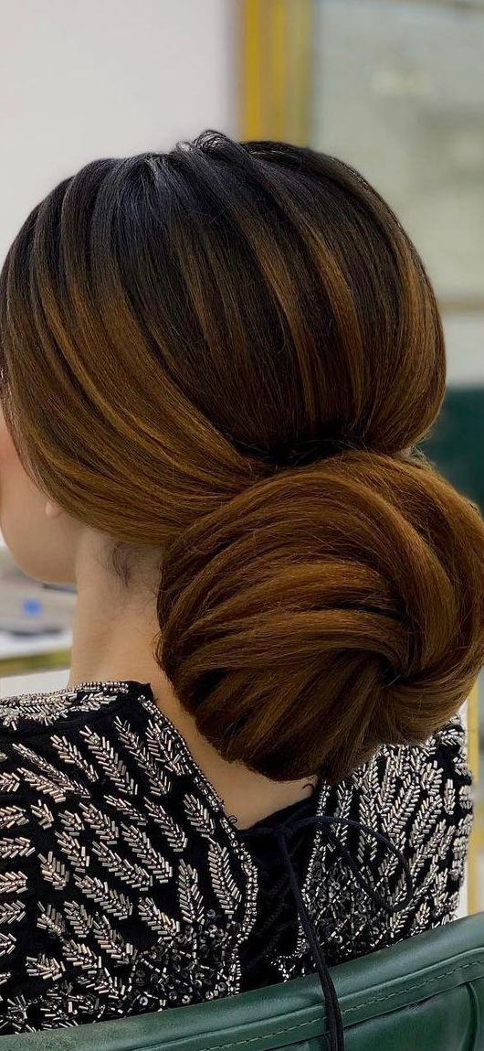 Sleek low bridal bun hairstyling