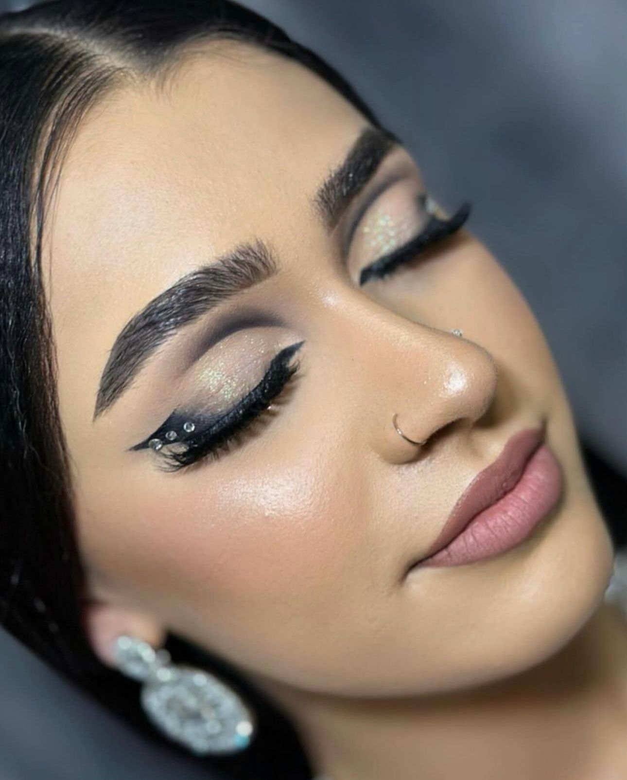 Macro close-up of antique gold eyeshadow with winged liner